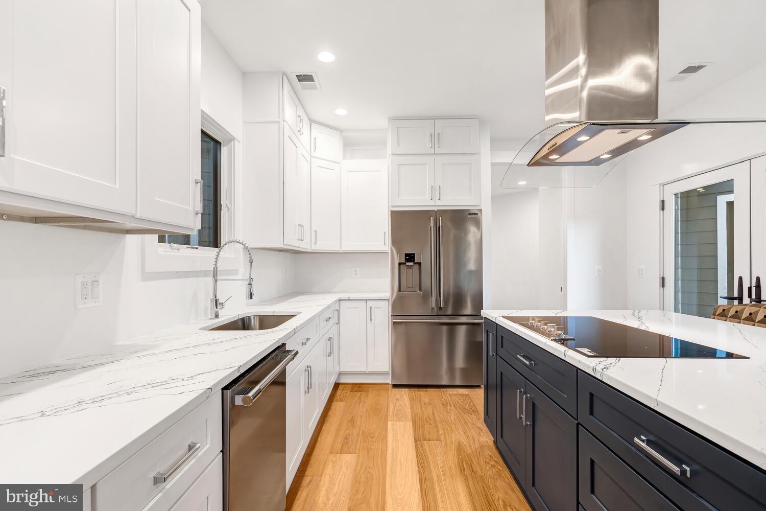 13711 Joyce Road Woodbridge, VA 22191 - Photo 11 of 54 a kitchen with stainless steel appliances granite countertop a sink and a refrigerator