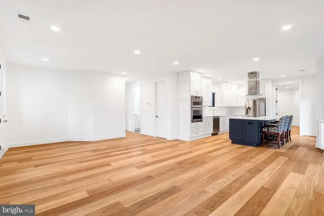 a view of a bedroom with wooden floor and bedroom space