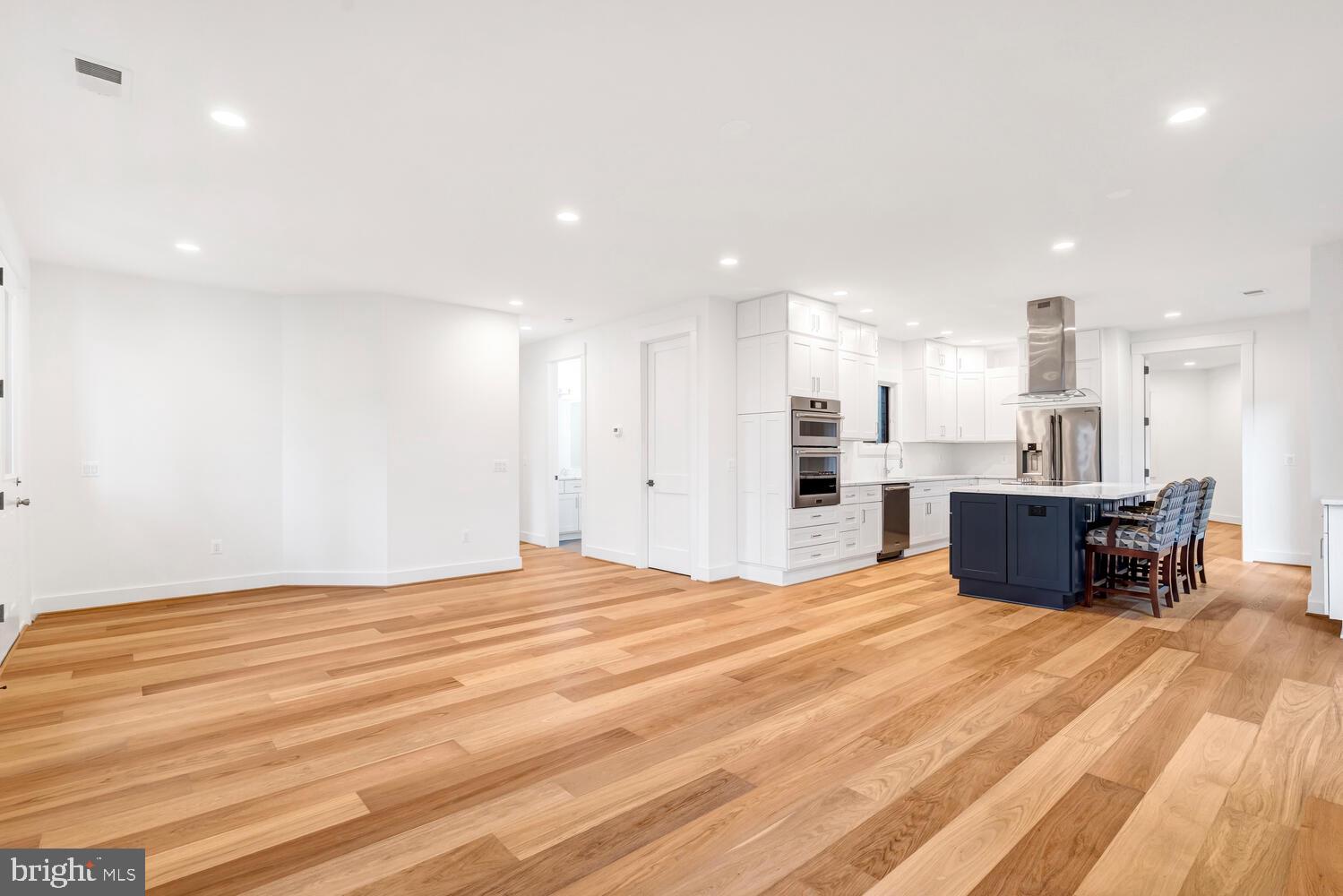 13711 Joyce Road Woodbridge, VA 22191 - Photo 15 of 54 a large room with kitchen view and a wooden floor