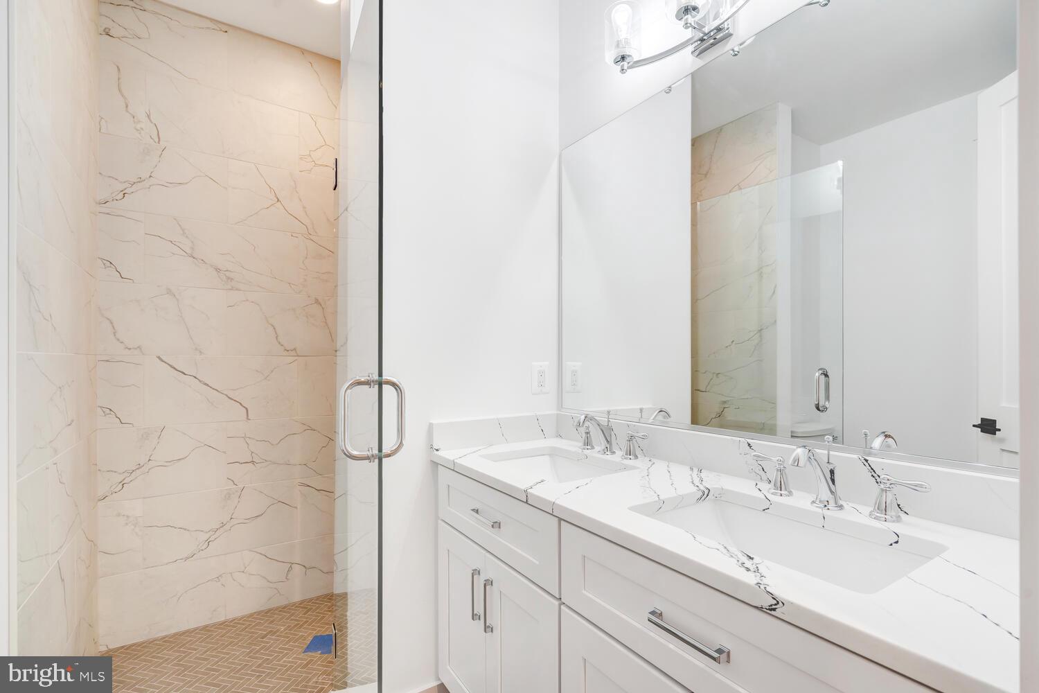 13711 Joyce Road Woodbridge, VA 22191 - Photo 19 of 54 a bathroom with a double vanity sink and a mirror