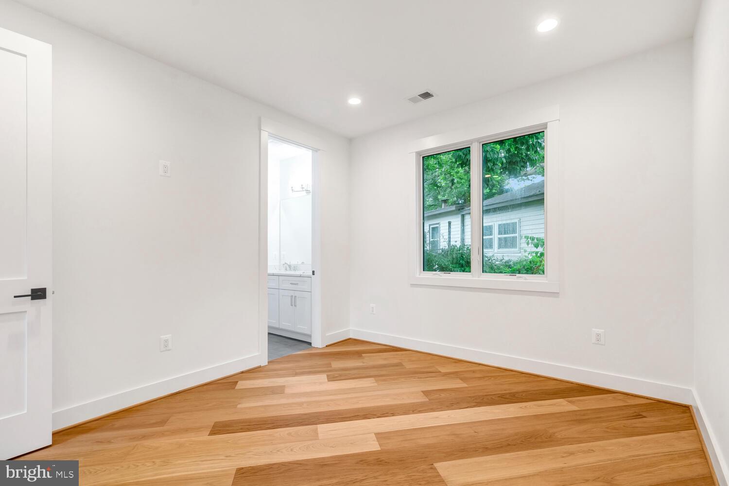 13711 Joyce Road Woodbridge, VA 22191 - Photo 20 of 54 a view of empty room with wooden floor and fan