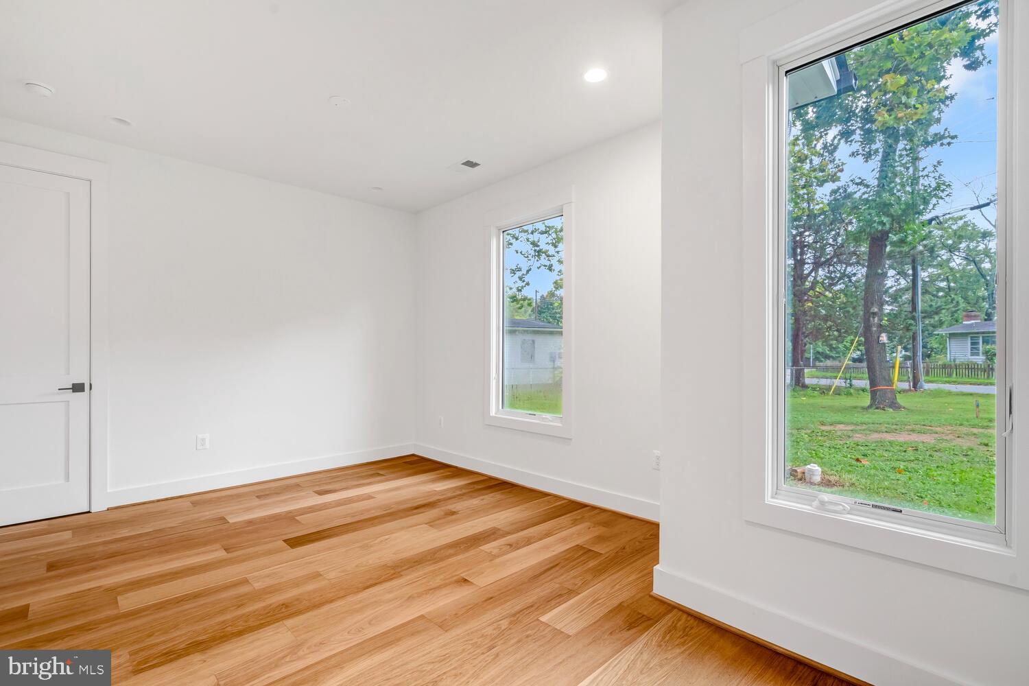 13711 Joyce Road Woodbridge, VA 22191 - Photo 21 of 54 a view of empty room with window and wooden floor