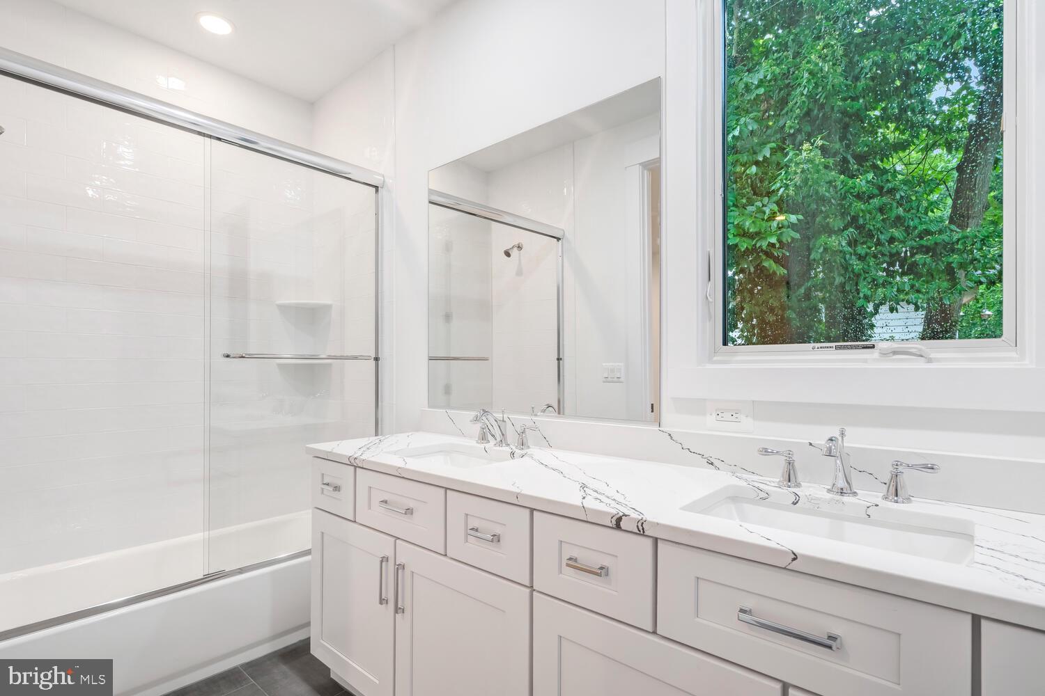 13711 Joyce Road Woodbridge, VA 22191 - Photo 23 of 54 a bathroom with a sink double vanity granite tub and shower