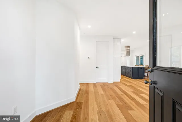 a view of a room with wooden floor and window