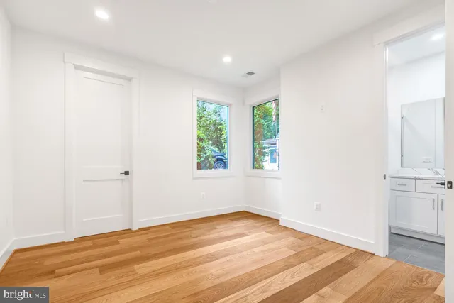 a view of a small space with wooden floor and a window