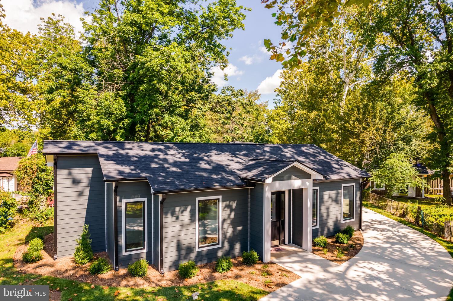 13711 Joyce Road Woodbridge, VA 22191 - Photo 46 of 54 a view of a house with large windows and a tree