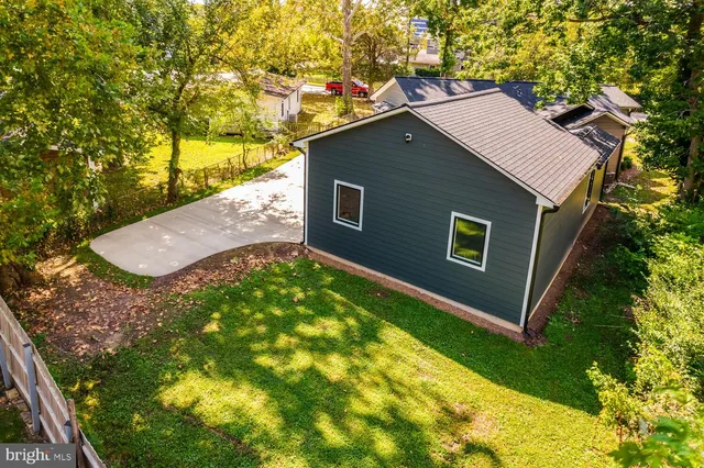 a brick house with yard in front of it