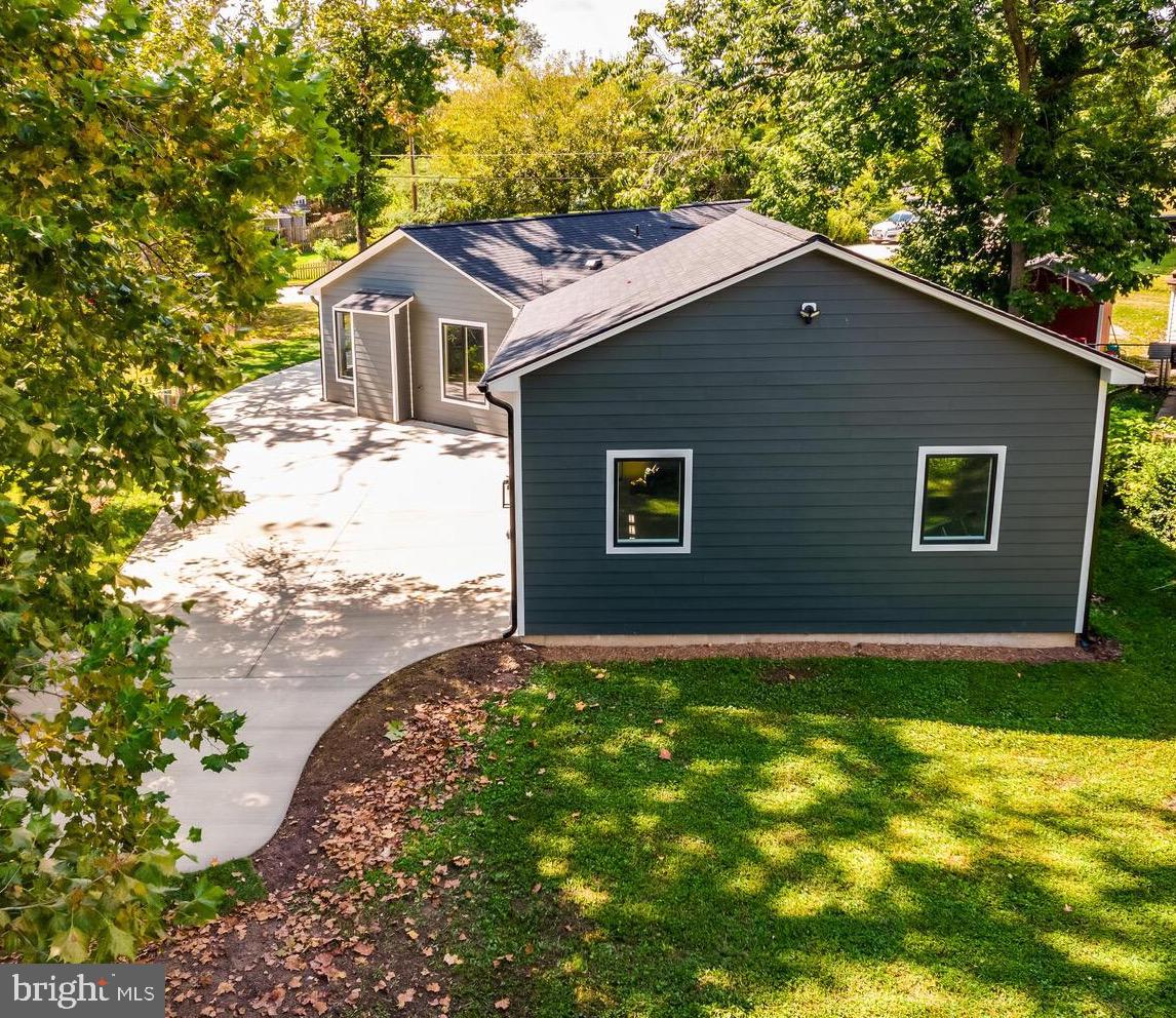 13711 Joyce Road Woodbridge, VA 22191 - Photo 5 of 54 a front view of a house with a yard