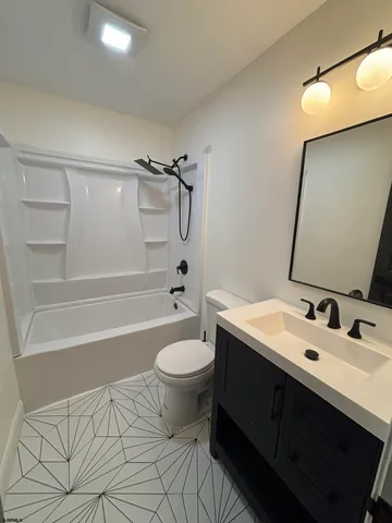 a bathroom with a sink toilet a mirror and shower