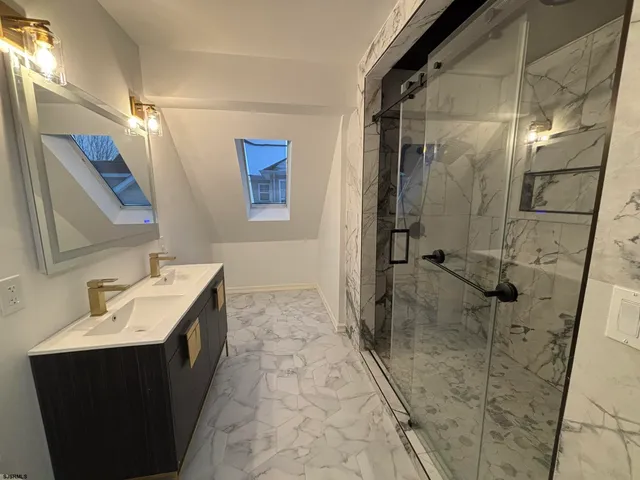 a bathroom with a sink mirror toilet and shower
