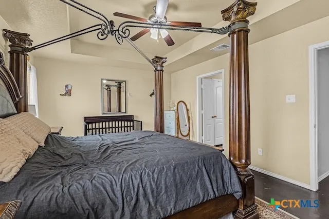 a bedroom with a bed next to a window