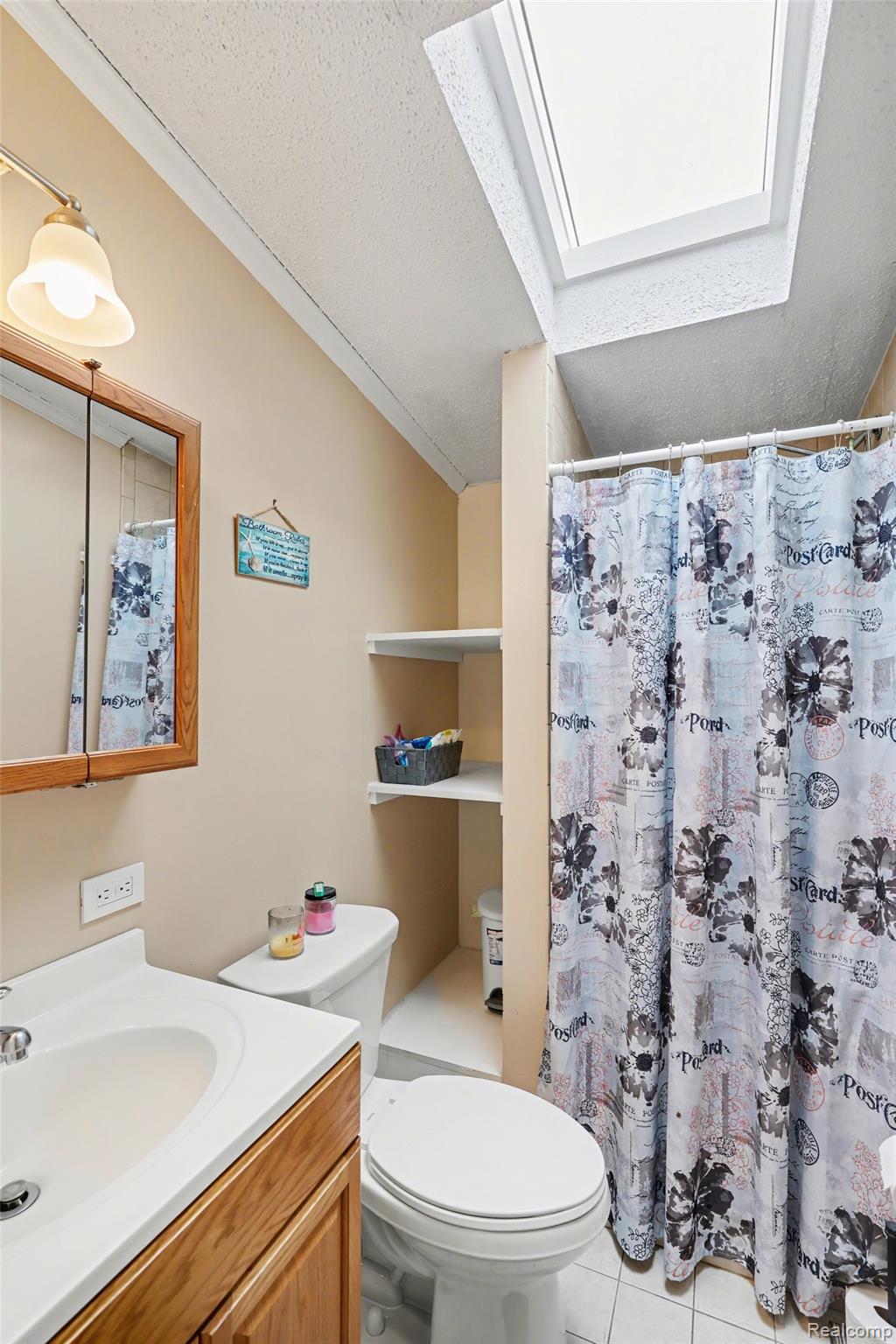 4458 Palms Road Casco, MI 48064 - Photo 23 of 32 Full bath with vanity, curtained shower, and light tile patterned flooring