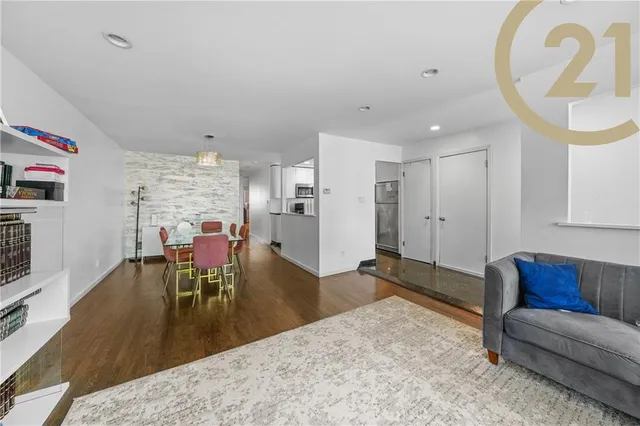 a view of a livingroom with furniture and a dining table
