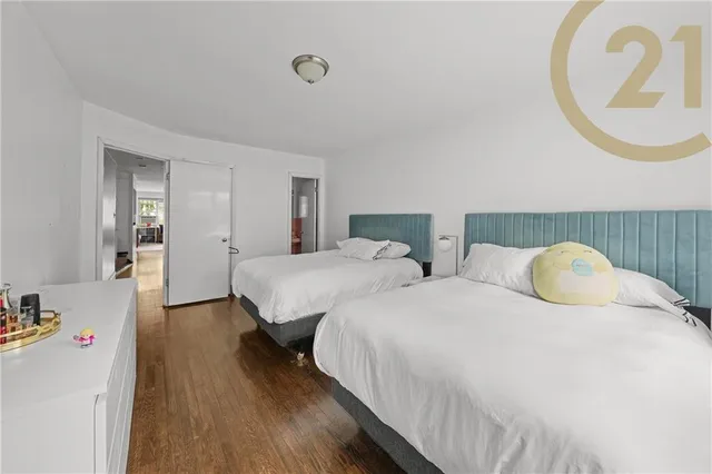 a bedroom with two beds and a chandelier