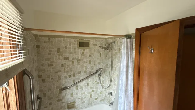 a bathroom with a shower and a glass door