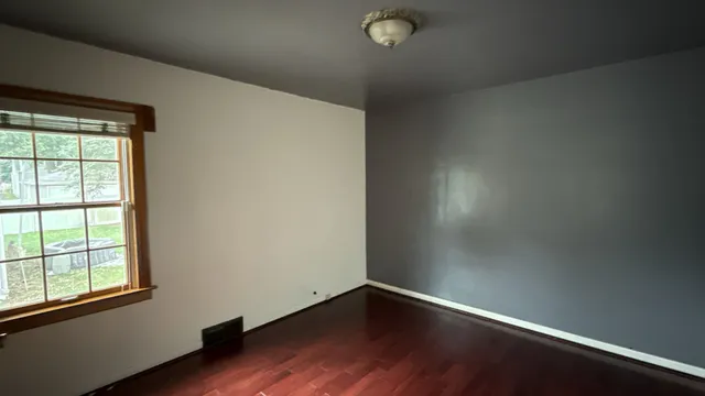 a view of an empty room with large windows