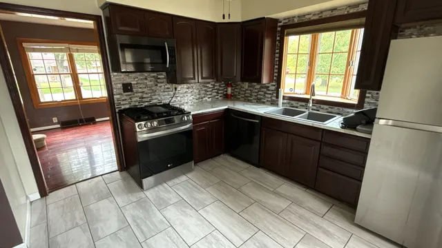 a kitchen with a stove a sink and a microwave