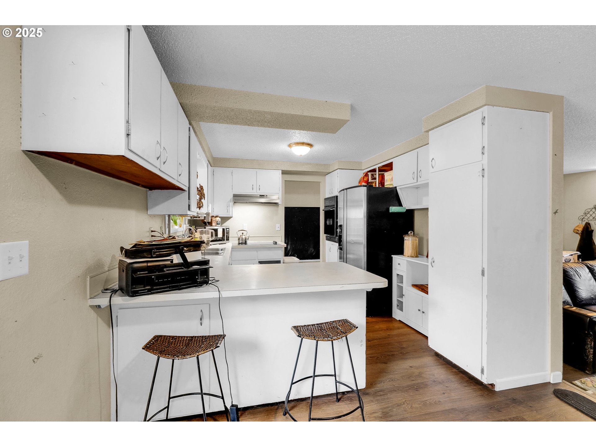 910 East 43rd Avenue Eugene, OR 97405 - Photo 13 of 47 a kitchen with stainless steel appliances a stove a refrigerator a sink a dining table and chairs