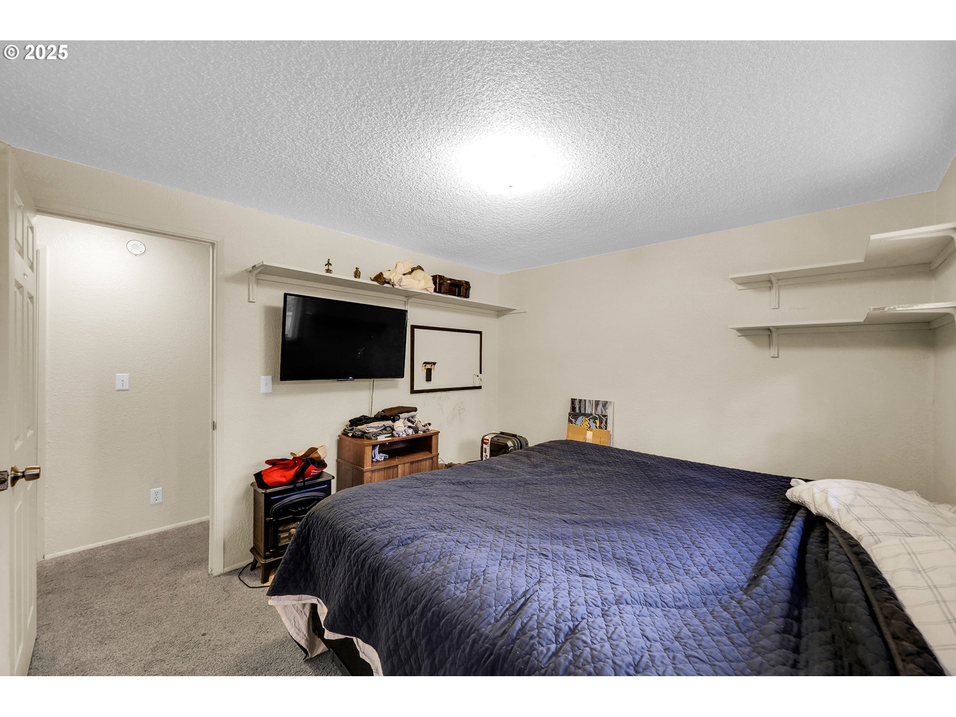 910 East 43rd Avenue Eugene, OR 97405 - Photo 22 of 47 a bed room with a bed and a television