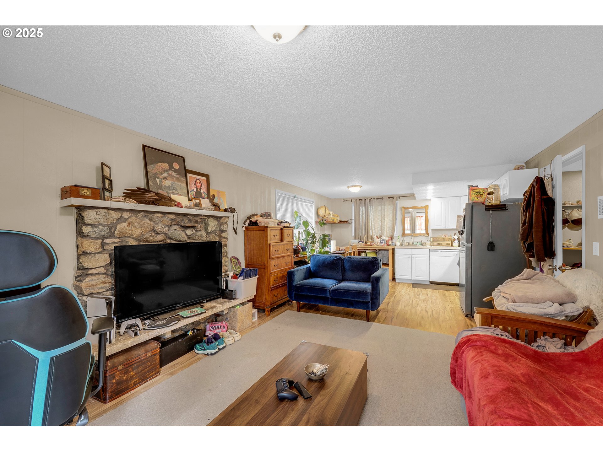 910 East 43rd Avenue Eugene, OR 97405 - Photo 33 of 47 a living room with furniture a flat screen tv and a fireplace