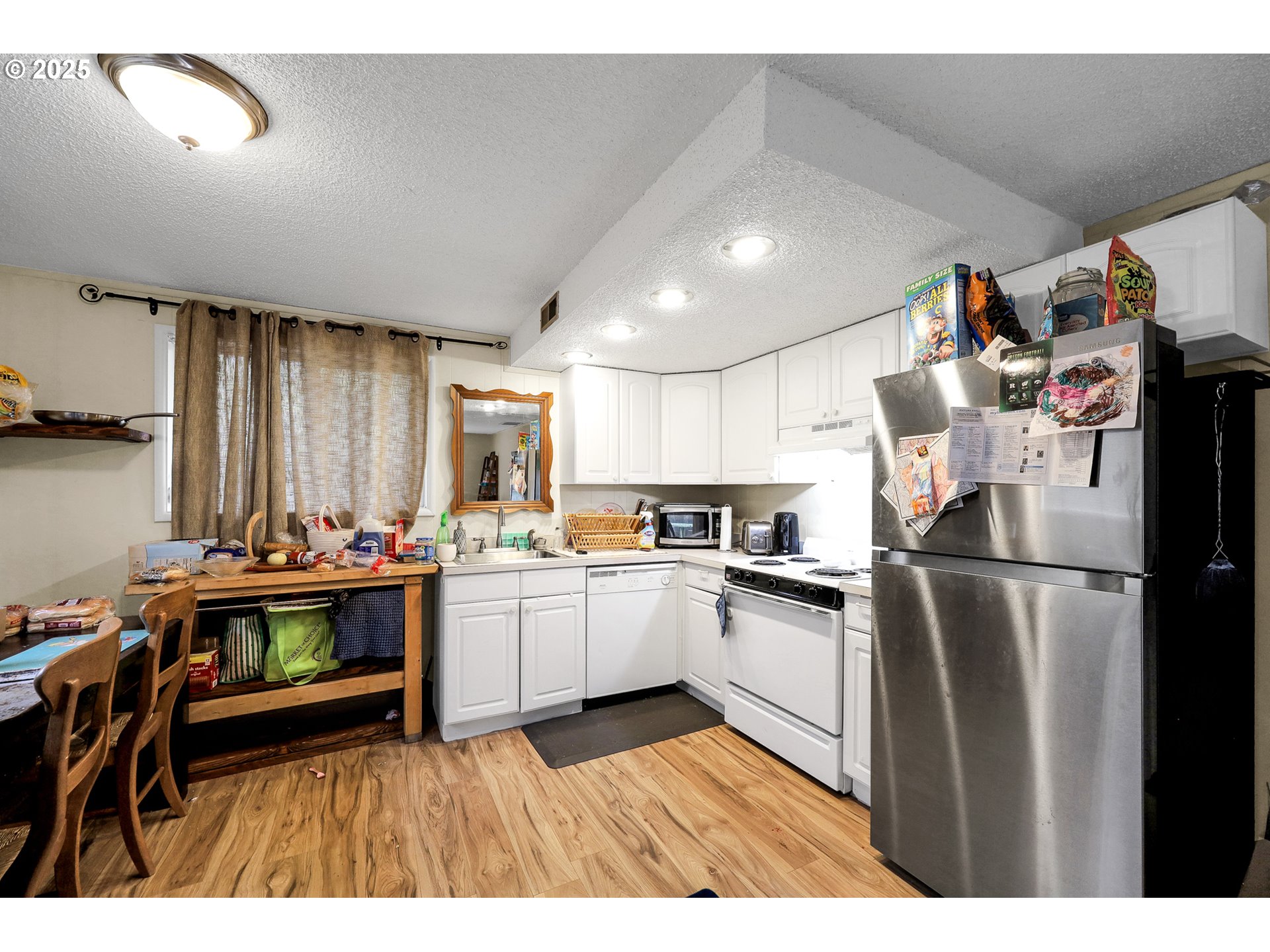910 East 43rd Avenue Eugene, OR 97405 - Photo 35 of 47 a kitchen with refrigerator and cabinets