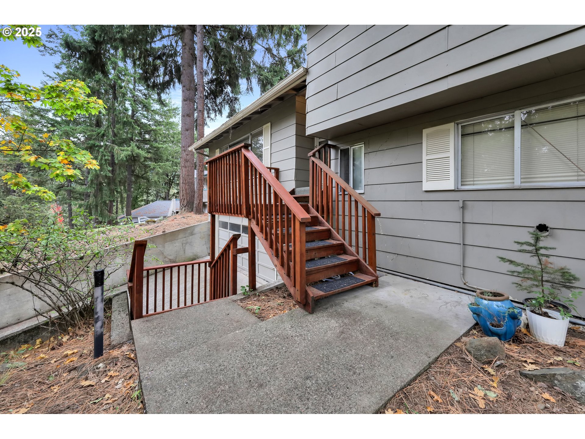 910 East 43rd Avenue Eugene, OR 97405 - Photo 4 of 47 a view of a wooden house with a small yard and wooden fence