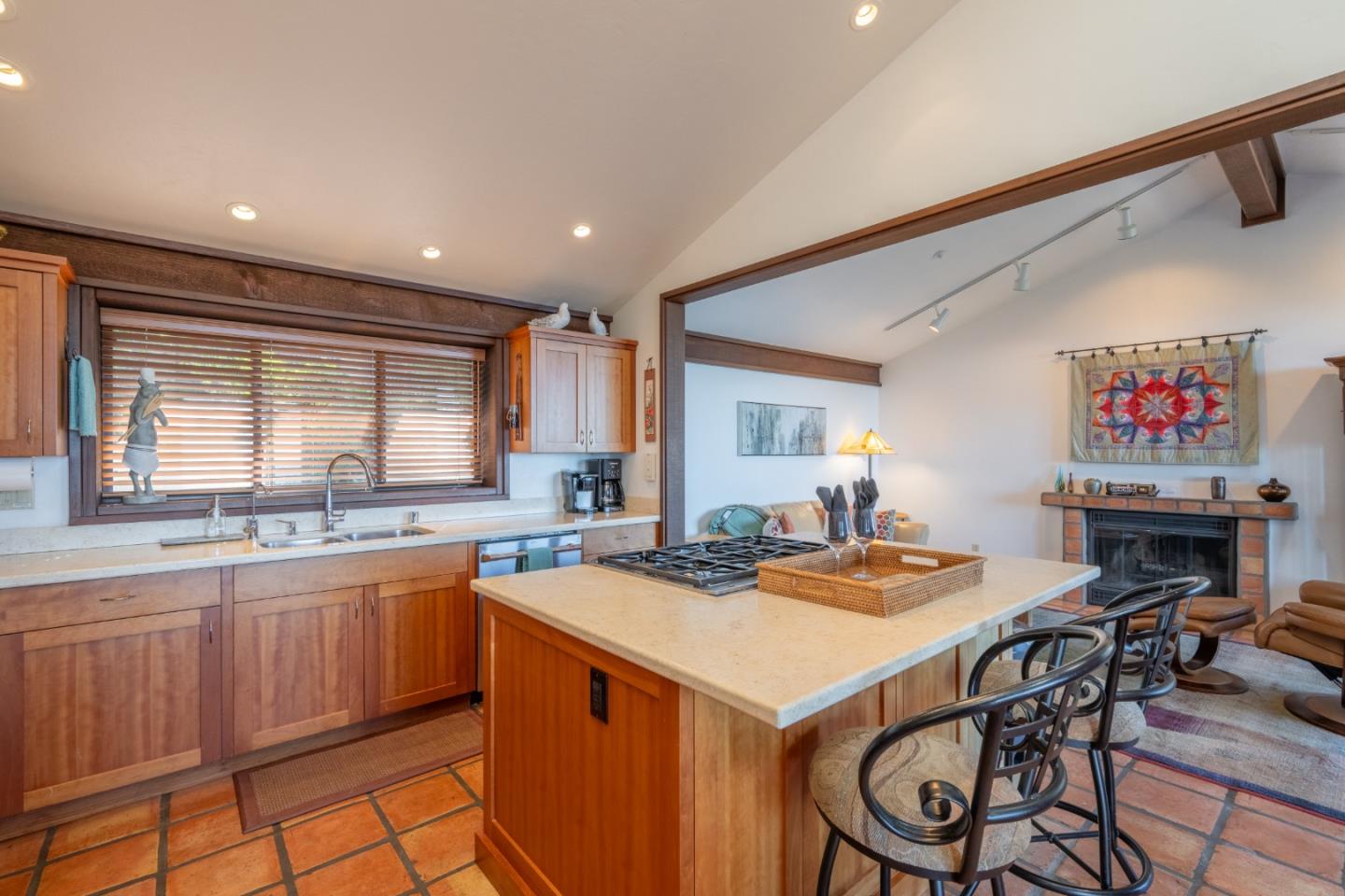 214 Crest Road Carmel, CA 93923 - Photo 10 of 29 a kitchen with a stove a sink a dining table and chairs