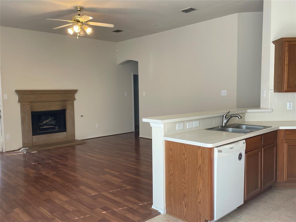 8271 Horse Whisper Lane Fort Worth, TX 76131 - Photo 2 of 12 a kitchen with a sink and a fireplace