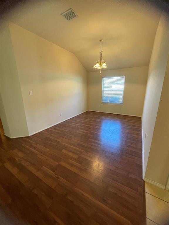 8271 Horse Whisper Lane Fort Worth, TX 76131 - Photo 6 of 12 an empty room with wooden floor and windows