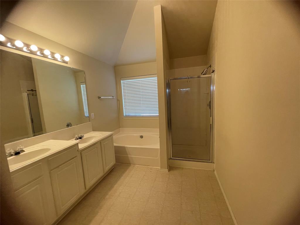 8271 Horse Whisper Lane Fort Worth, TX 76131 - Photo 10 of 12 a bathroom with a tub sink and mirror