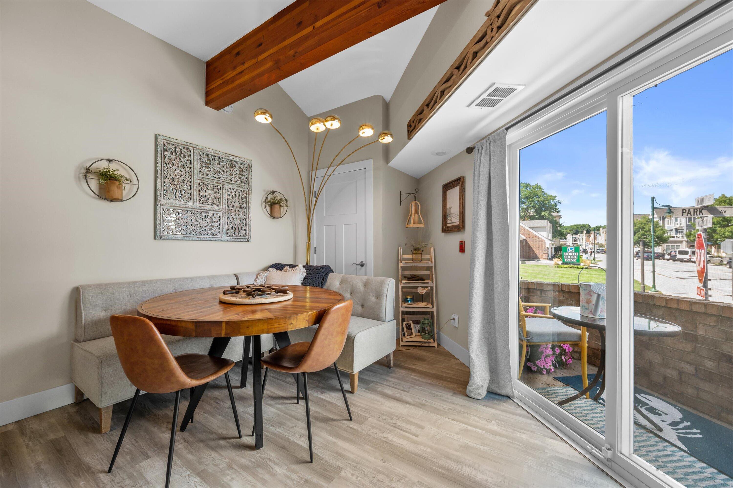 100 Main Street, Unit 102 Pewaukee, WI 53072 - Photo 12 of 30 Sliding glass doors open to a private patio with downtown views.