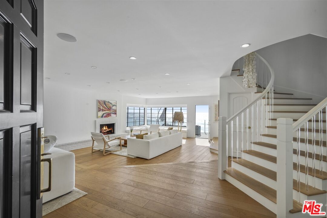 31500 Victoria Point Road Malibu, CA 90265 - Photo 9 of 53 a living room with furniture and a wooden floor