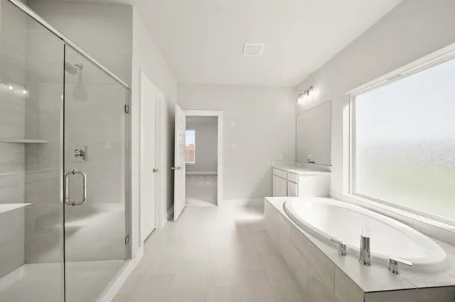 a bathroom with a tub and shower