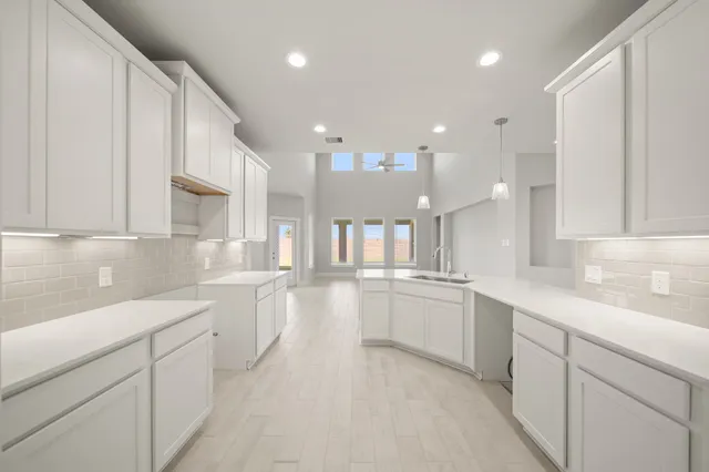 a kitchen with a sink and cabinets