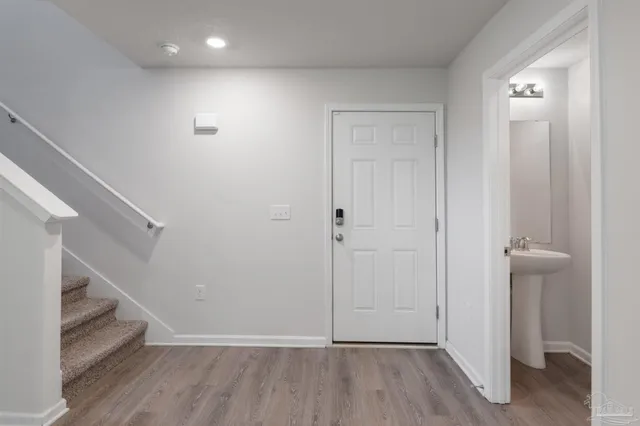 a view of entryway with hallway and wooden floor