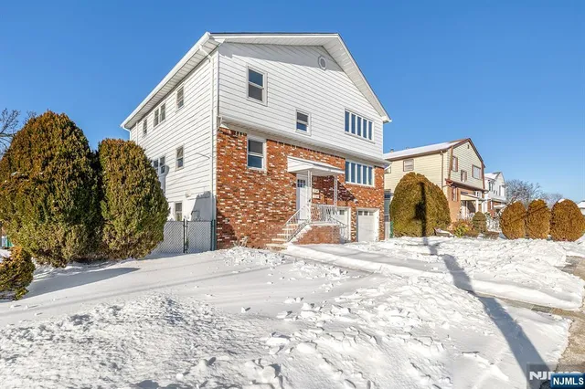 a view of a white house with a yard