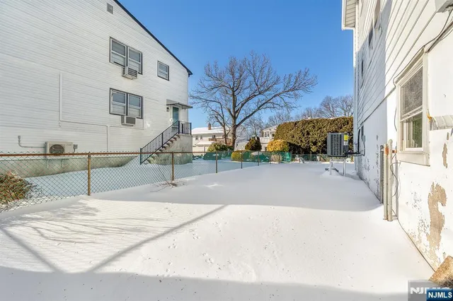 a view of a building with snow on the road