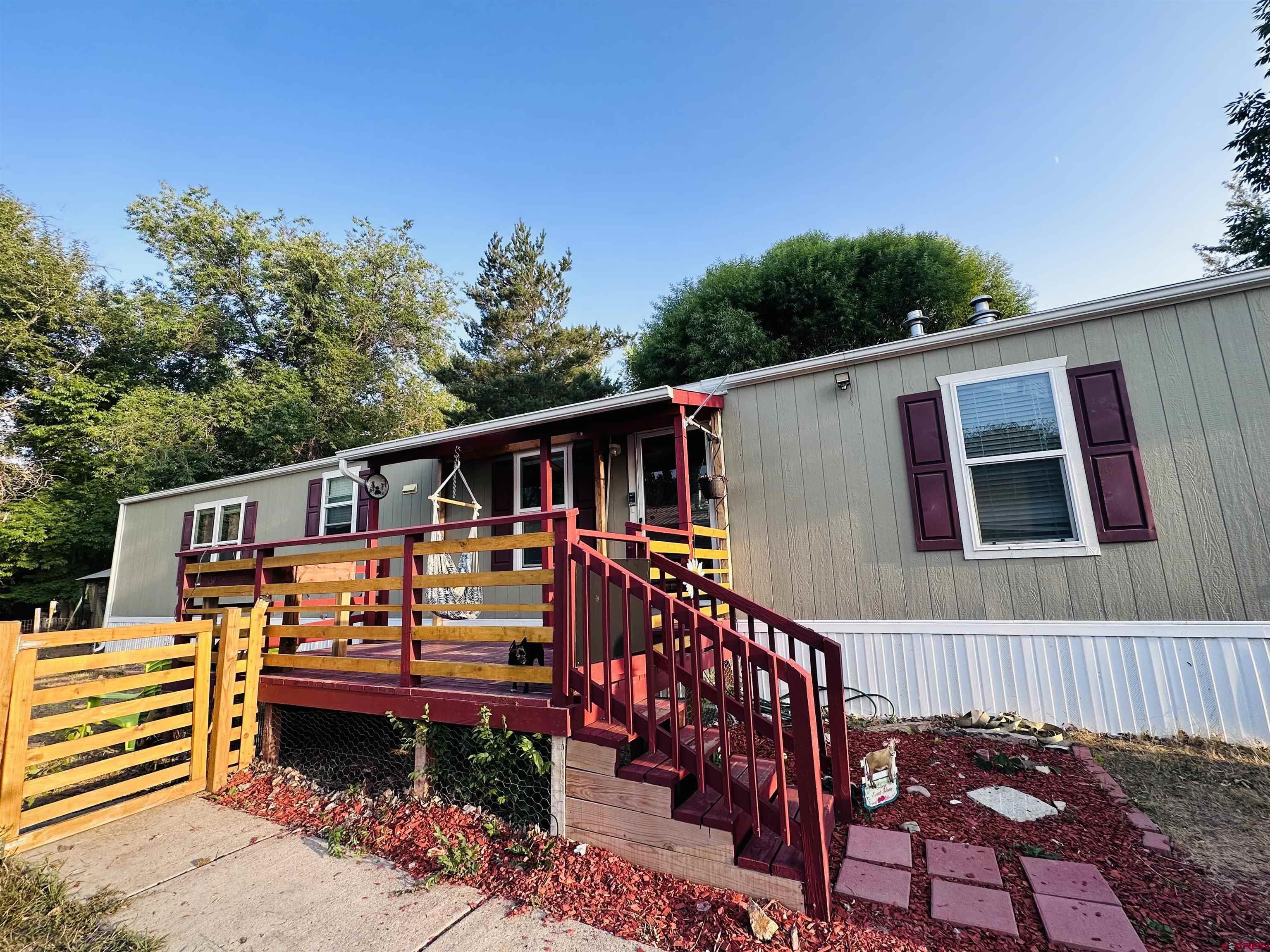 62880 Lasalle Road, Unit 185 Montrose, CO 81401 - Photo 1 of 19 a front view of a house with a balcony