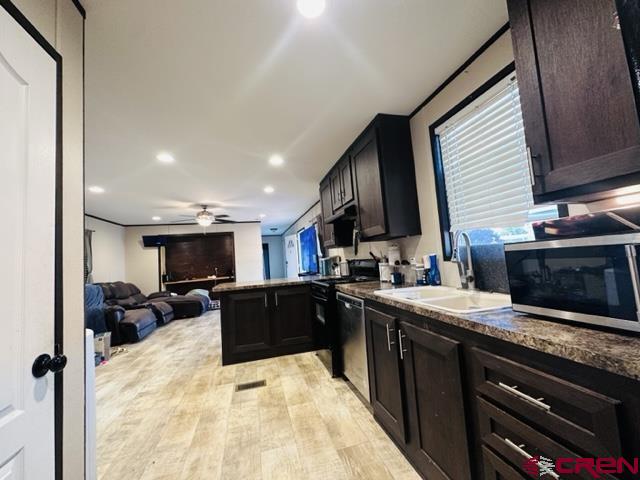 62880 Lasalle Road, Unit 185 Montrose, CO 81401 - Photo 4 of 19 a kitchen with stainless steel appliances kitchen island granite countertop a sink stove and refrigerator