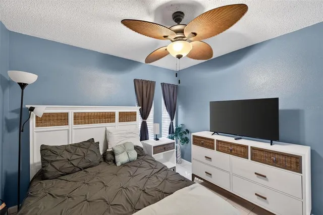 a bedroom with a bed closet and flat screen tv