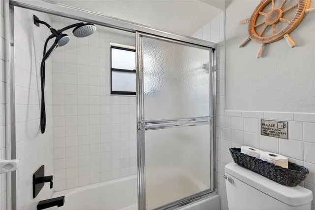 a view of a patio with chairs and potted plants