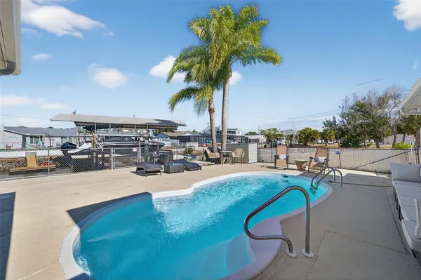 a view of a house with backyard sitting area and garden