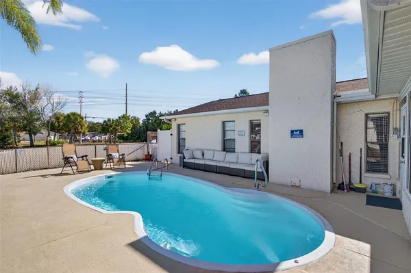 a view of a balcony with dining table and chairs