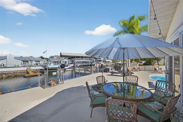 a view of a house with backyard sitting area and garden