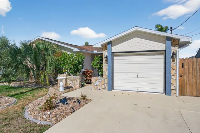a palm tree sitting in front of a house with a yard