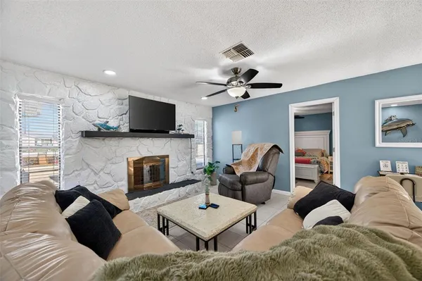 a living room with furniture ceiling fan and a rug