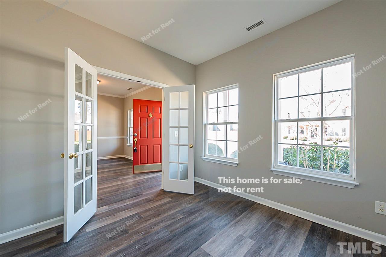5304 Neuse Forest Road Raleigh, NC 27616 - Photo 14 of 26 a view of an empty room with wooden floor and a window