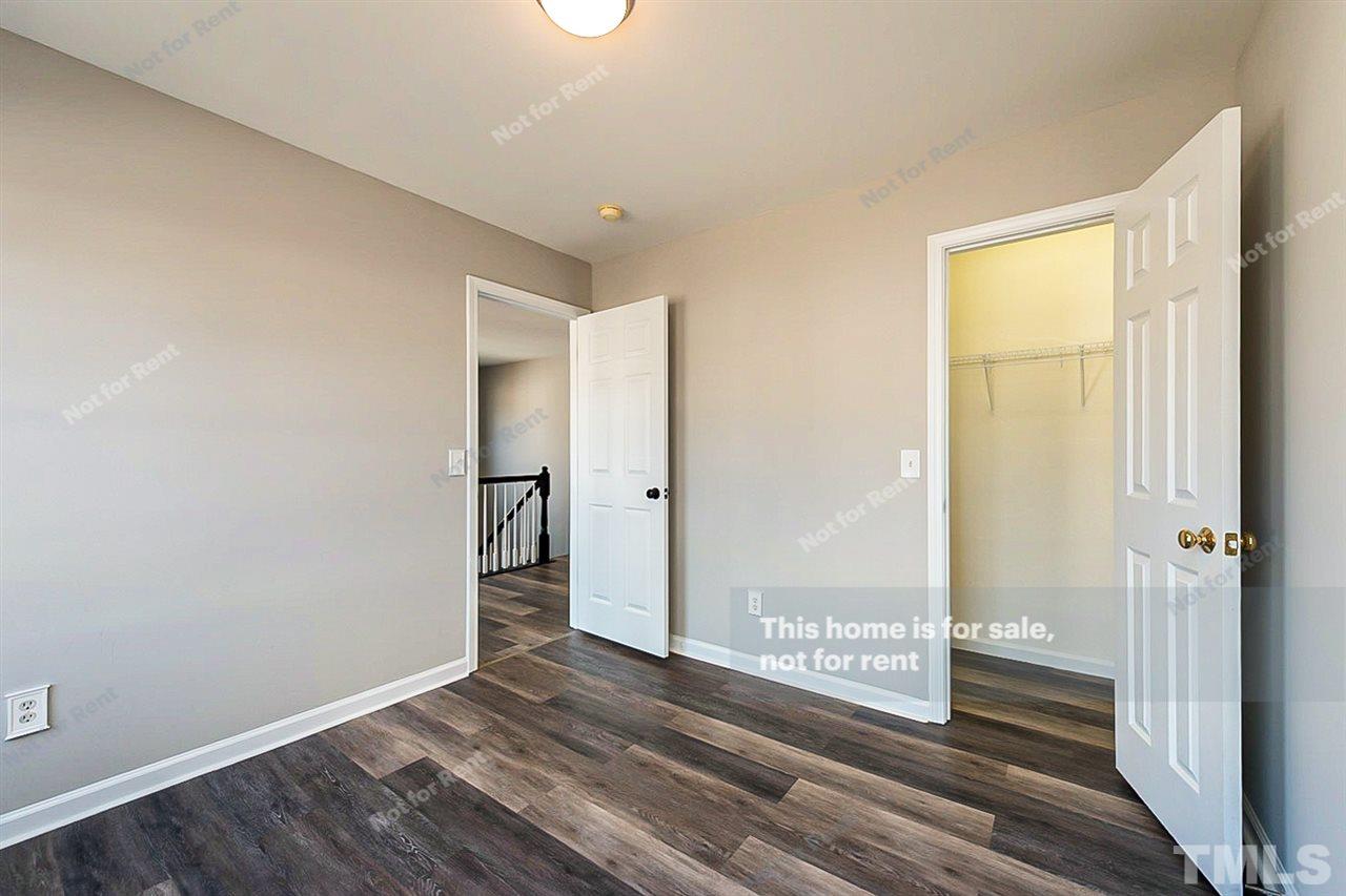 5304 Neuse Forest Road Raleigh, NC 27616 - Photo 23 of 26 a view of a hallway with wooden floor and a bathroom