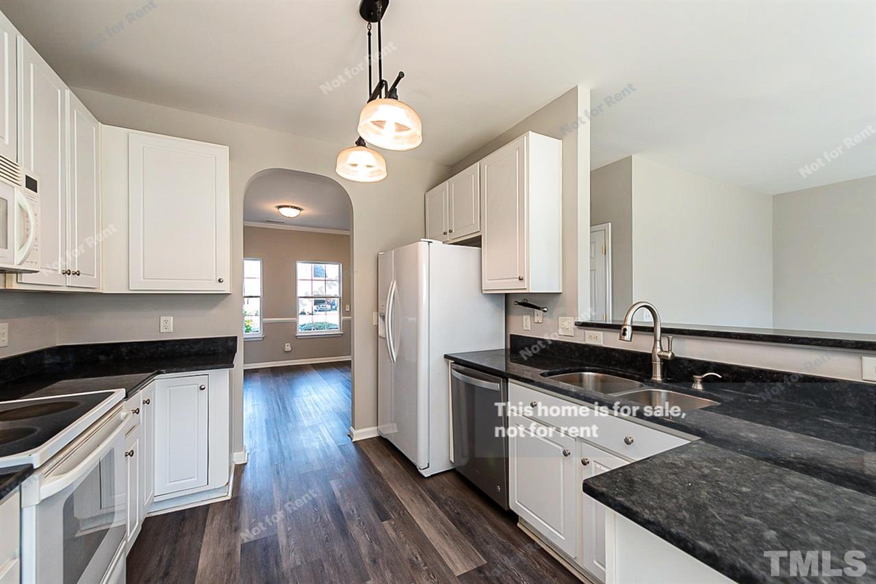 5304 Neuse Forest Road Raleigh, NC 27616 - Photo 4 of 26 a kitchen with granite countertop a sink stainless steel appliances and cabinets