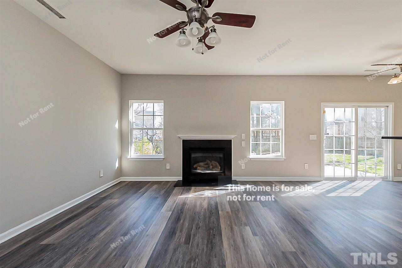 5304 Neuse Forest Road Raleigh, NC 27616 - Photo 5 of 26 wooden floor fireplace and windows in an empty room